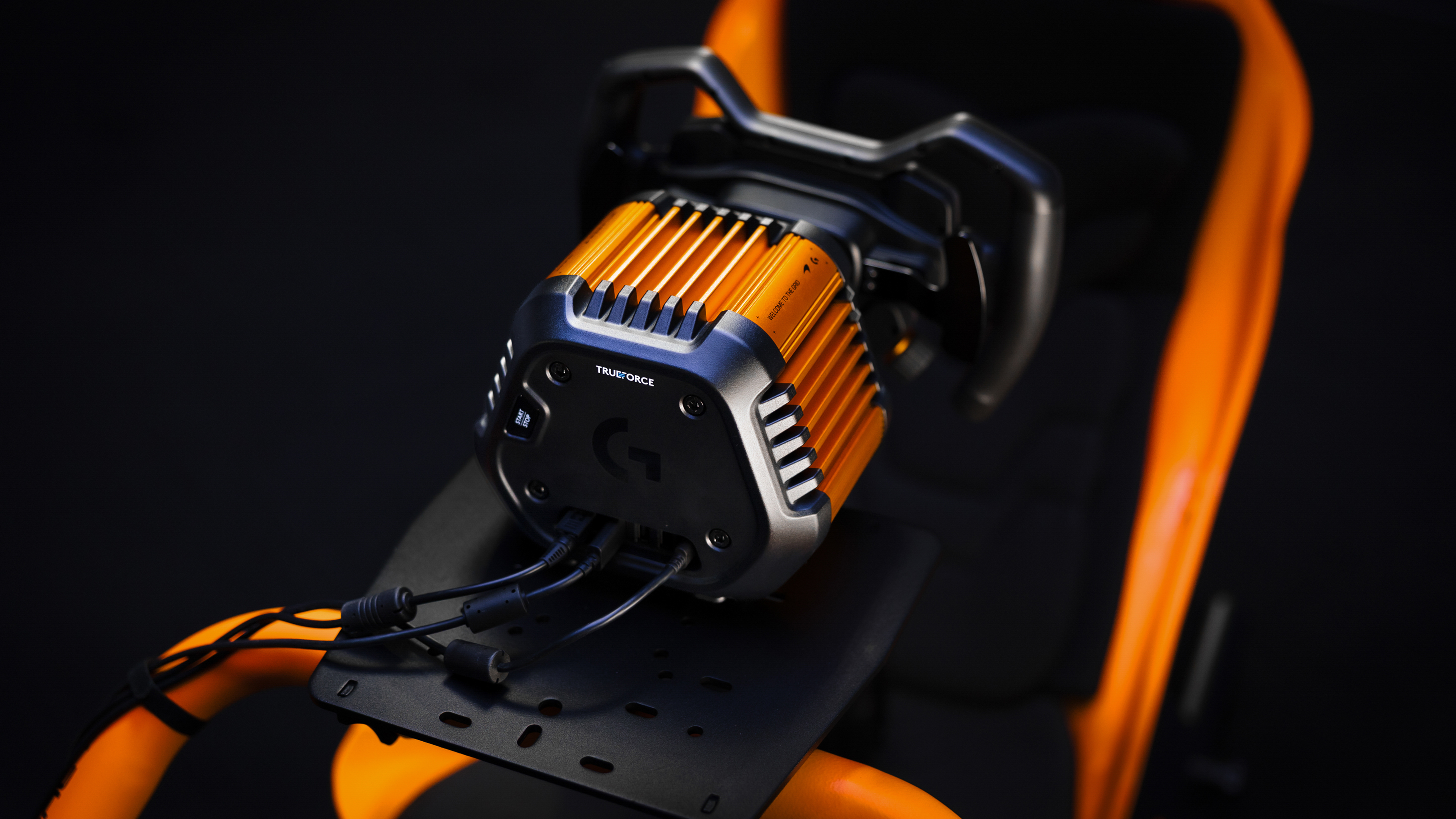 The Logitech G RS50 McLaren Racing Edition wheel, base and pedals in McLaren papaya.
